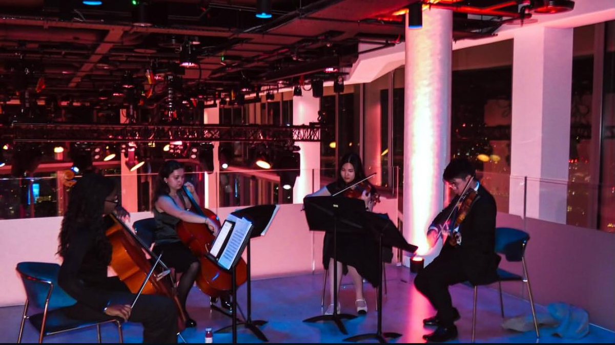 A string quartet performing at a society event